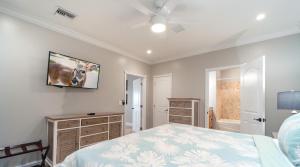 a bedroom with a bed and a picture of a cow on the wall at Fishermen`s Paradise in Big Pine Key +48 photos