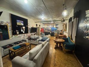 a living room with couches and chairs and a table at Bardak hostel in Cusco