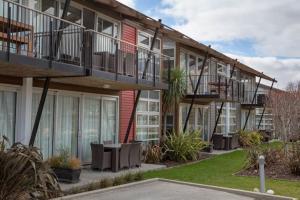 弗兰克顿Cosy & Comfortable Studio Marina 203a的带阳台和桌子的建筑,位于庭院