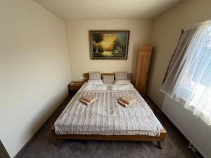 a bedroom with two beds and a picture on the wall at Bee house 12 in Odorheiu Secuiesc