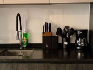a kitchen counter with a sink and utensils at Nuevo y Comodo excelente ubicacion in Santiago