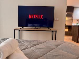 a television on a table with the netflix sign on it at Nuevo y Comodo excelente ubicacion in Santiago