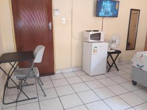 a room with a microwave on top of a refrigerator at Yana House in Polokwane