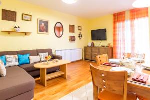 a living room with a couch and a table at Family friendly house with a swimming pool Dugobabe, Zagora - 12617 in Dugobabe