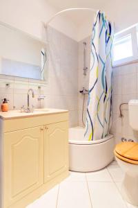 a bathroom with a tub and a toilet and a sink at Family friendly house with a swimming pool Dugobabe, Zagora - 12617 in Dugobabe