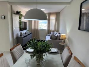 a living room with a table and a couch at Magnificent coverage in São Roque