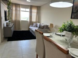 a living room with a table and a couch at Magnificent coverage in São Roque