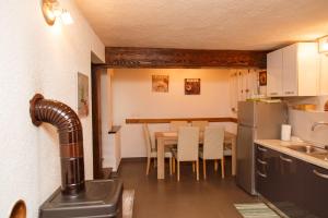 a kitchen and dining room with a table and chairs at Holiday house with a parking space Zlobin, Gorski kotar - 15452 in Benkovac Fužinski