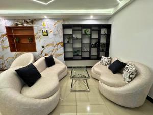 a living room with two chairs and a table at City Tower Hotel in Lima