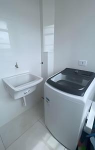 a white bathroom with a sink and a toilet at Magnificent coverage in São Roque +26 photos