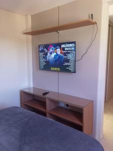 a bedroom with a tv on a wall at Magnificent coverage in São Roque