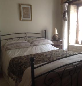 a bed with white sheets and pillows in a bedroom at Le Grenier 1 Rue Verte Tusson 16140 France in Tusson +7 photos