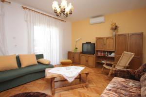 a living room with a couch and a tv at Apartments with parking space Opric, Opatija - 7695 in Opric