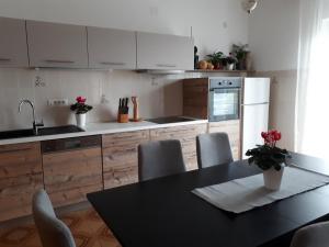 a kitchen with a table and chairs and a refrigerator at Apartments with parking space Opric, Opatija - 7695 in Opric