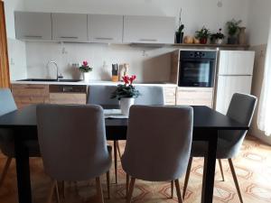 a kitchen with a table and chairs in a kitchen at Apartments with parking space Opric, Opatija - 7695 in Opric +16 photos