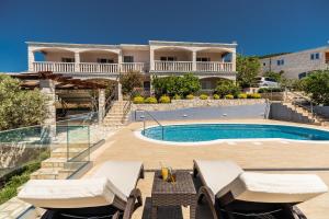 a villa with a swimming pool and a house at Seaside apartments with a swimming pool Prizba, Korcula - 10056 in Brnistrova