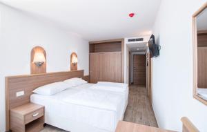 Postel nebo postele na pokoji v ubytování Villa Paradiso 2