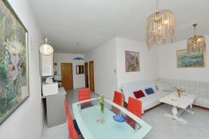 a living room with a couch and a table at Apartments by the sea Vir - 24953 in Vir +18 photos