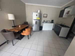 a kitchen with a table and a refrigerator at Vivaldi Apartments in Willemstad +5 photos