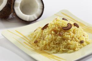 a plate of food with rice and a coconut at Hotel O JNTU college Near LULU mall, KPHB Colony. in Hyderabad +57 photos