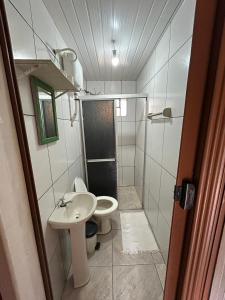 a small bathroom with a toilet and a sink at Recanto Ana Valentin in Paranaguá