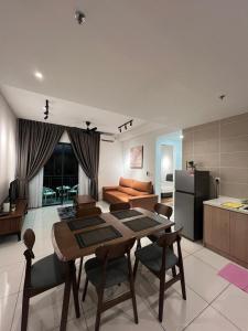 a kitchen and living room with a table and chairs at Sunway Onsen beautiful view 4-6pax in Tambun
