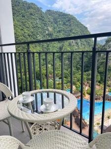 a balcony with a table and chairs and a view of a resort at Sunway Onsen beautiful view 4-6pax in Tambun