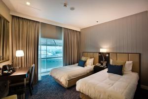 Uma cama ou camas num quarto em Ambassador Transit Hotel - Terminal 3