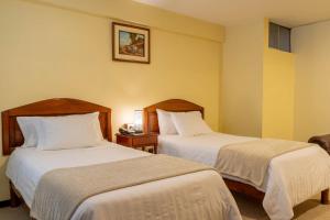 Cama o camas de una habitación en El Marquez Huancayo