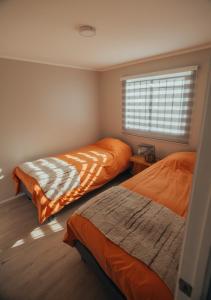 a bedroom with two beds and a window at casa ikigai in Curacautín