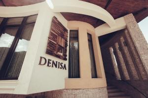 a sign on the side of a building at Denisa Boutique in Poiana Brasov