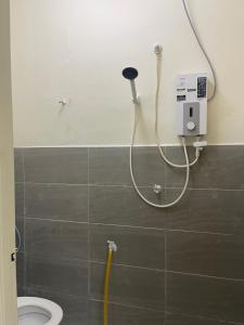 a shower in a bathroom with a toilet at Homestay Bajet Kg Telaga Mas Paka in Paka +12 photos