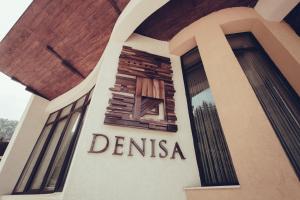 a building with a sign that reads dentinas at Denisa Boutique in Poiana Brasov