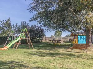 a playground with a slide and a bench in a park at Gîte familial en Auvergne avec jardin, ping-pong, proche stations thermales, animaux acceptés - FR-1-489-127 in Mazirat