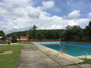 an empty swimming pool with a playground at B&B U Kaplicky in Všelibice