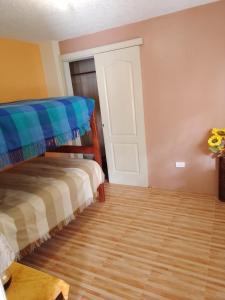 a bedroom with a bunk bed and a wooden floor at Lejaim 