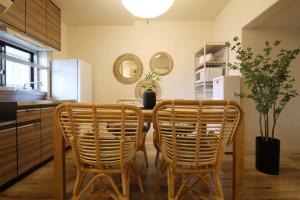 a kitchen with a table and two chairs at ウィズ八王子レジデンス 102 in Hachioji +27 photos