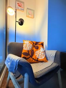 a blue room with a chair with pillows on it at Apt in Heart of Melbourne w Pool,Gym,Sauna,WiFi in Melbourne +12 photos