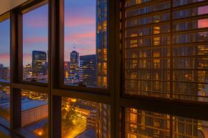a view of a city skyline from a window at Apt in Heart of Melbourne w Pool,Gym,Sauna,WiFi in Melbourne