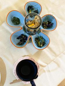 a table with two plates and a bowl of food at Casa Ñusta- Living culture & regenerative tourism in Cusco