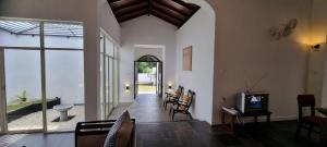 a living room with a tv and a room with a hallway at Villa Red, Battaramulla in Sri Jayewardenepura Kotte