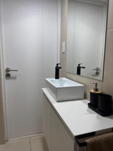 a bathroom with a white sink and a mirror at corazón de Maipú in Maipú