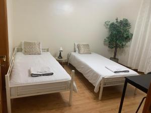 two beds sitting next to each other in a room at Anjos Station Lisbon Hostel in Lisbon +6 photos