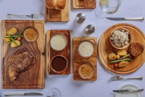 a white table topped with wooden plates of food at Italia Hotel Cairo in Cairo