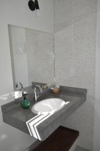a bathroom counter with a sink and a mirror at Pousada Villa Terracotta in Miguel Pereira +73 photos