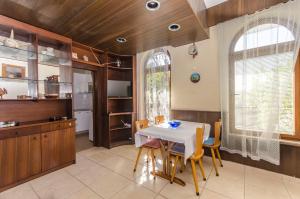a kitchen with a table and chairs in a room at Apartments Marija in Rogoznica
