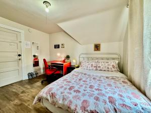 a bedroom with a bed and a desk with a red chair at Private Room with Shared Amenities 10 Minutes to Airport and Walking Distance to Bus Station in Seattle