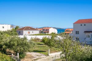 a view of a town with houses and the ocean at Apartments with parking space Kastel Stafilic, Kastela - 24155 in Kaštela