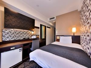a hotel room with two beds and a desk at APA Hotel Tsukiji Ekiminami in Tokyo