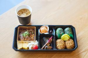 a lunch box with food and a cup of coffee at Fairfield by Marriott Mie Kumano Kodo Mihama in Mihama